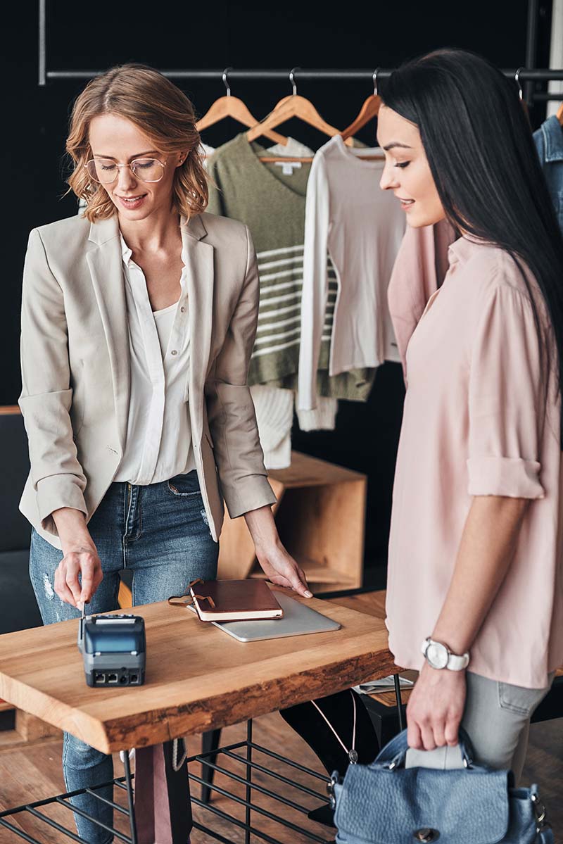 Image Of A Woman Paying For Her Dresses